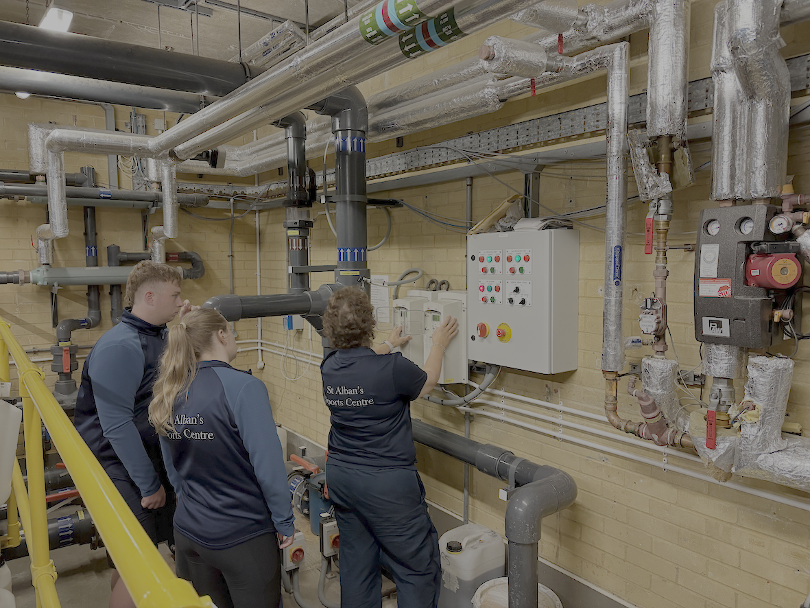 A photo of pool plant operator course students undergoing practical training in a pool plant room. 