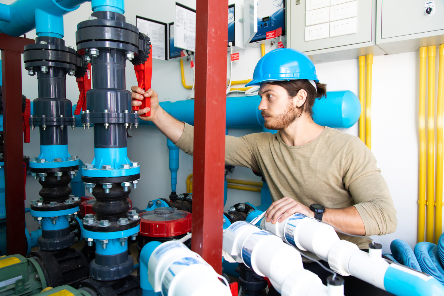 A pool plant operator carrying out maintenance tasks in a pool plant room.